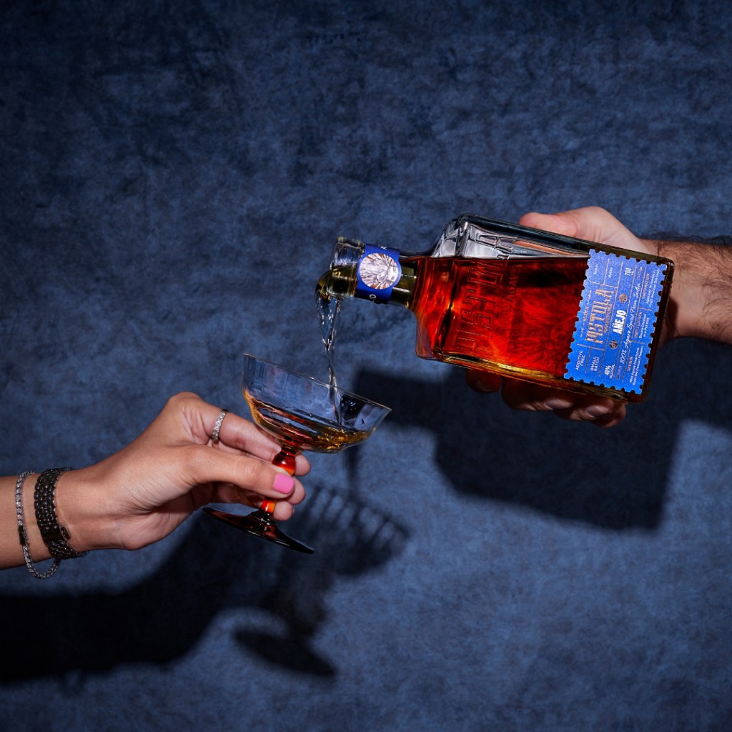 Pouring from a bottle of Maya Pistola. The Agaveist. 